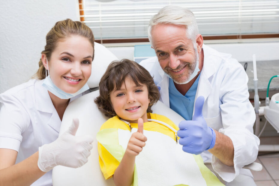 Dentist in Kapolei, dental hygienist and boy patient smiling at the camera